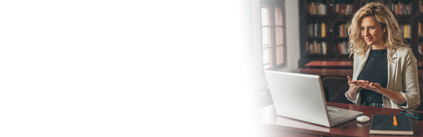 Young woman teaching a lesson on a laptop in a library